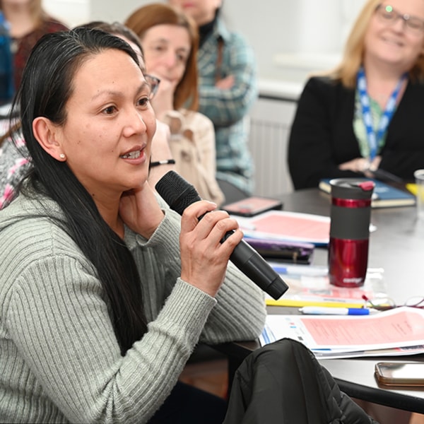 Member at a conference speaking into a microphone